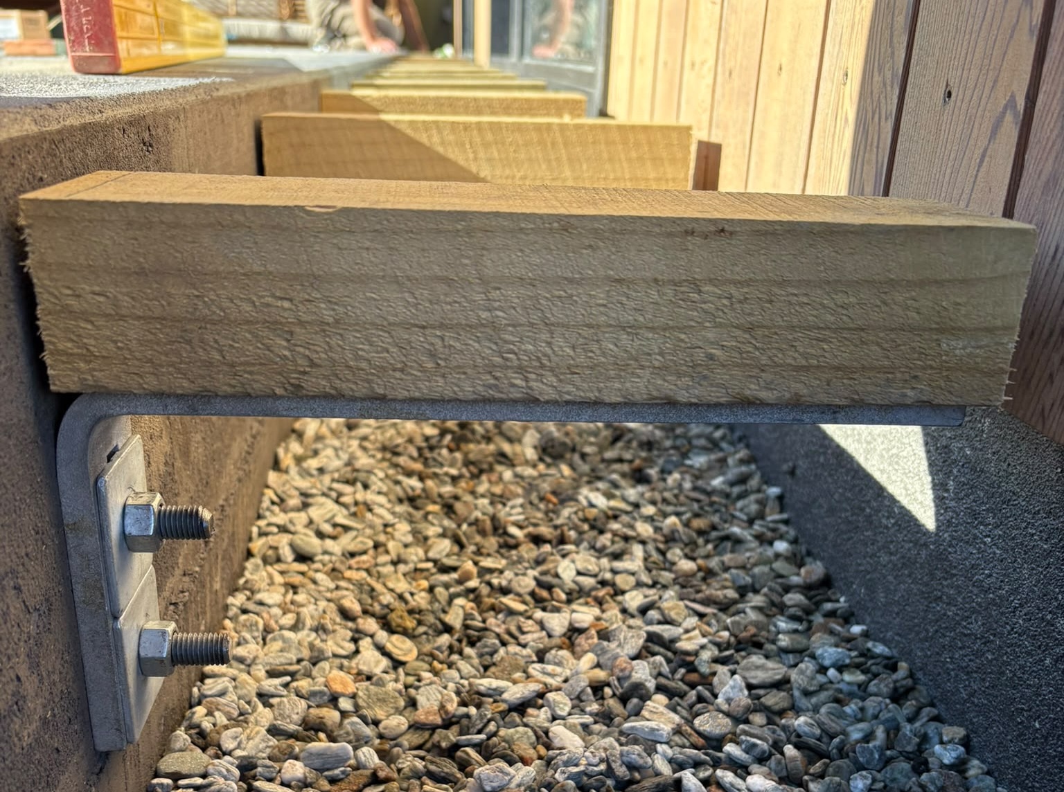 Even Entry bracket system installed with timber deck boards and gravel drainage channel