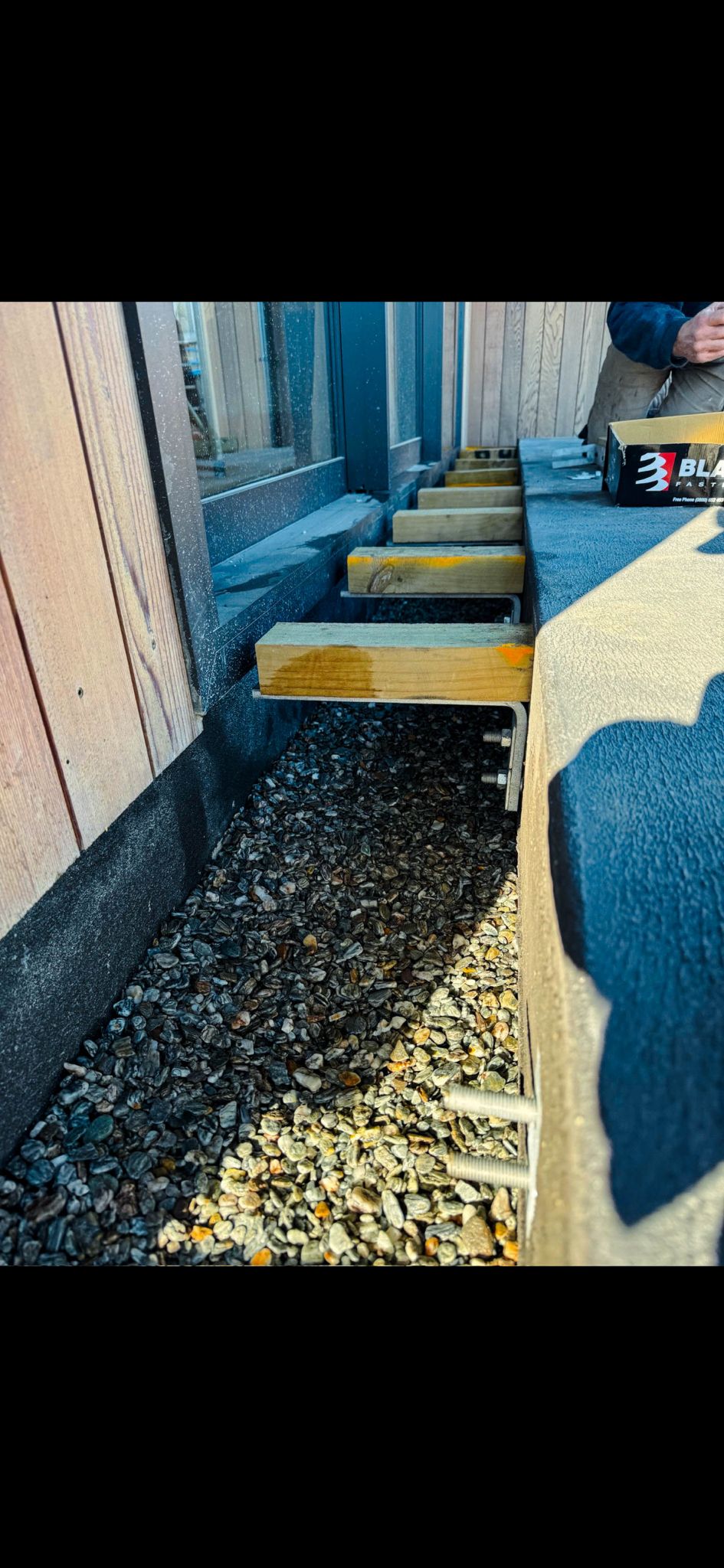 Completed entry deck with gravel drainage and cladding
