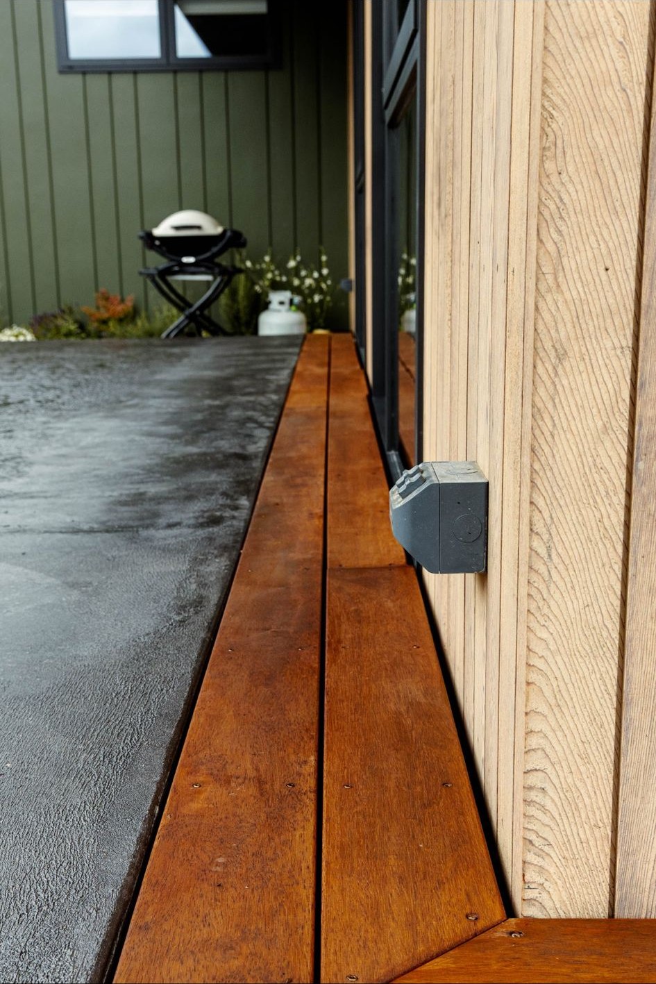Wide angle view of finished outdoor deck with door access