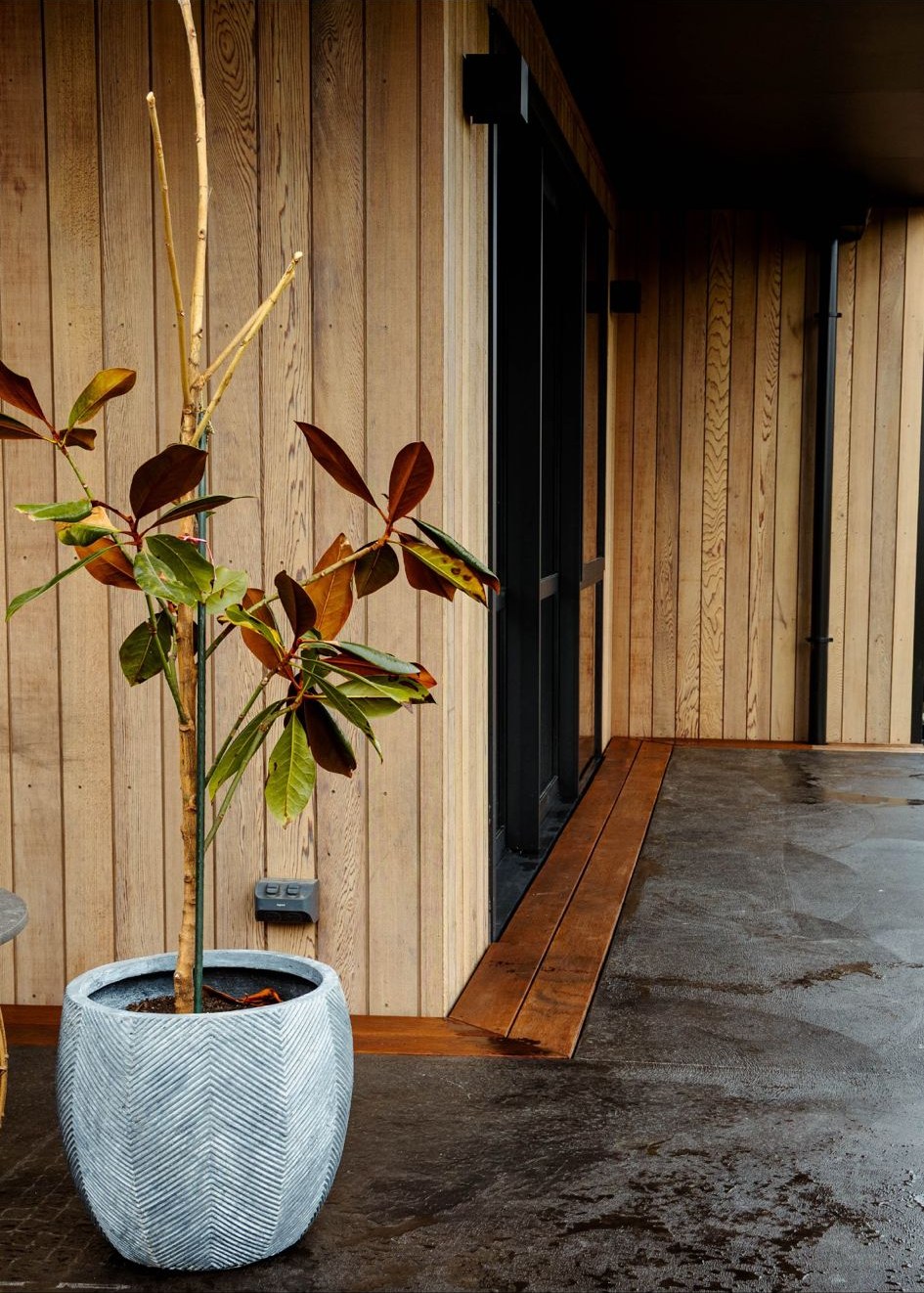 Close-up of decking boards level with door threshold