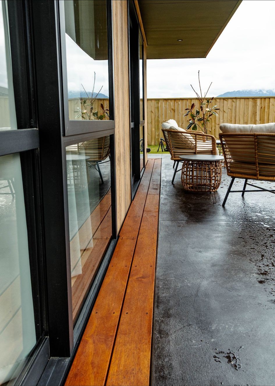 Finished deck patio with outdoor furniture and mountain backdrop